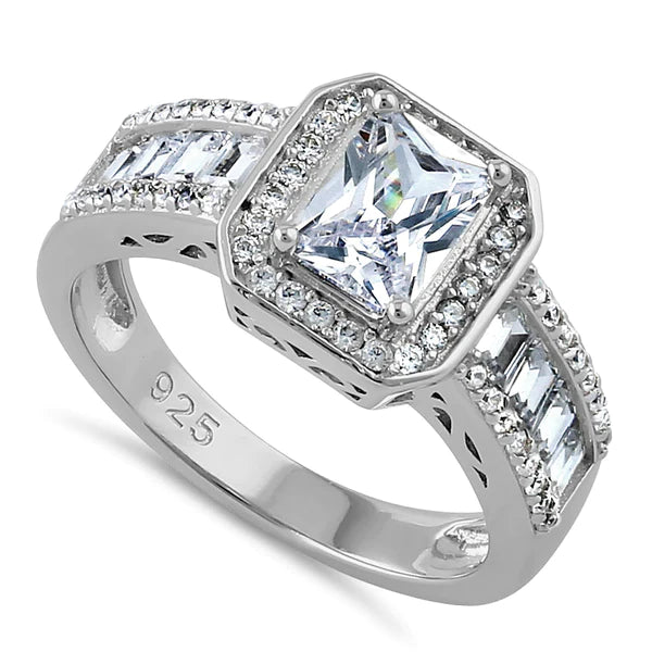 Features a 1 carat emerald cut center stone
Surrounded by a halo of round stones
Baguette and round stones also run down each side of the band
Sterling silver, plated with Rhodium
Available in sizes 4 through 12